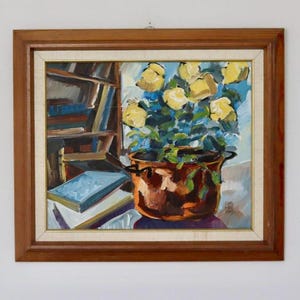 May include: Oil painting in a wooden frame. The artwork depicts a still life with yellow roses in a copper pot, a bookshelf, and books. The painting has a warm color palette with shades of brown, yellow, and blue.