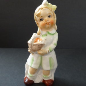 Sweet Young Girl With Rosey Cheeks And A Bow In Her Hair Carrying A Basket Vintage Figurine