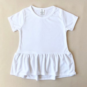 May include: White short-sleeved t-shirt dress with a ruffled hem.