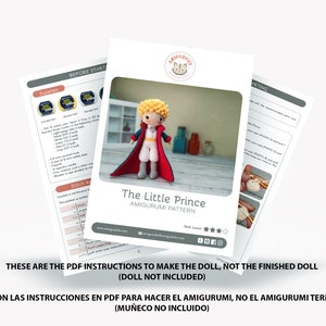 May include: PDF instructions for crocheting a The Little Prince amigurumi doll. The pattern includes a red and blue outfit with a yellow crown and a cape. The doll is shown in the image.