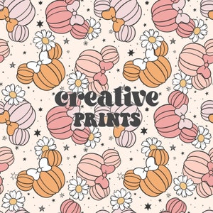 May include: A seamless pattern featuring pink and orange cartoon mouse ears with bows, white daisies, and gold stars on a light peach background. The text "creative prints" is in the center of the pattern.