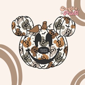 May include: A whimsical Halloween-themed design featuring a pumpkin with Mickey Mouse ears. The pumpkin is decorated with smiling jack-o'-lantern faces in shades of orange and gray, with black bats and stars. The text "Creative Prints" is visible.