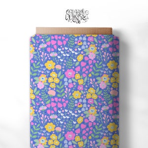May include: A seamless pattern featuring a variety of colourful flowers on a light blue background. The flowers are pink, yellow, and white, and the pattern is perfect for fabric, wallpaper, or other creative projects.