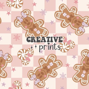 May include: A seamless pattern featuring gingerbread cookies shaped like a bear with a bow on its head. The cookies are on a pink and white checkered background with snowflakes and stars. The text "CREATIVE prints" is in the center of the pattern.