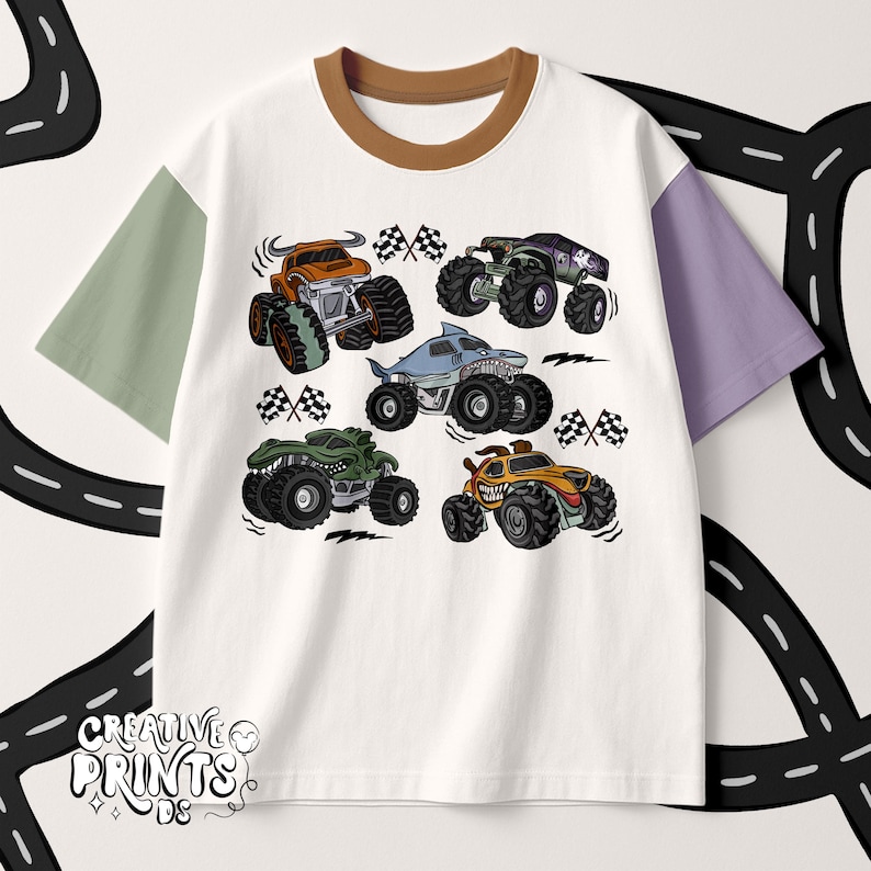 May include: White t-shirt with a brown collar and color-blocked sleeves in green and purple. The shirt features a graphic of six cartoon monster trucks in various colors, with checkered flags.