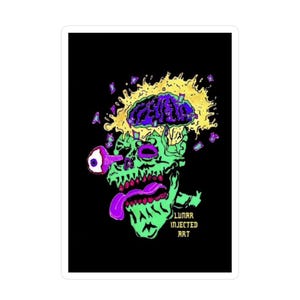 May include: A rectangular sticker featuring a green skull with a purple tongue and a single eye protruding from the socket. Above the skull is a yellow explosion with purple brain matter. The text LUNAR INJECTED ART is printed in yellow.