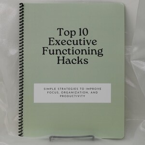 May include: A sage green spiral-bound notebook with black text that reads Top 10 Executive Functioning Hacks. Below this, a white rectangular block contains the text Simple Strategies to Improve Focus, Organization, and Productivity.