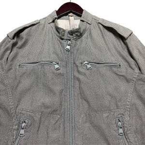 A vintage Diesel moto biker jacket with a checkered design featuring a full zip front, utility pockets and a streetwear aesthetic. Perfect for casual layering unisex fashion.
