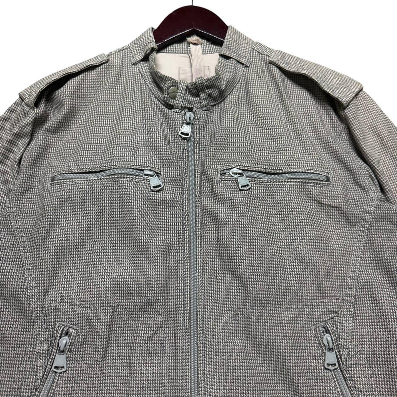 A vintage Diesel moto biker jacket with a checkered design featuring a full zip front, utility pockets and a streetwear aesthetic. Perfect for casual layering unisex fashion.