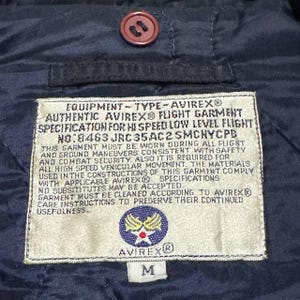Vintage Avirex MA 1 Bomber Jacket Navy USA Flight Jacket 90s Streetwear Military Jacket Classic Zip Up Nylon Bomber Coat For Men And Women Rare Avirex USA Outerwear Piece With Iconic Back Logo Design.