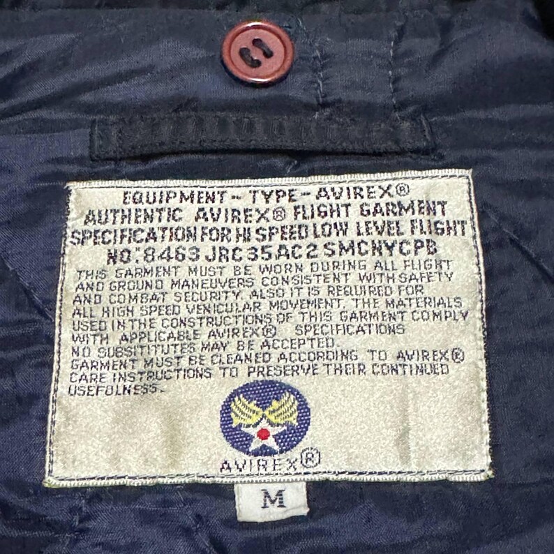 Vintage Avirex MA 1 Bomber Jacket Navy USA Flight Jacket 90s Streetwear Military Jacket Classic Zip Up Nylon Bomber Coat For Men And Women Rare Avirex USA Outerwear Piece With Iconic Back Logo Design.