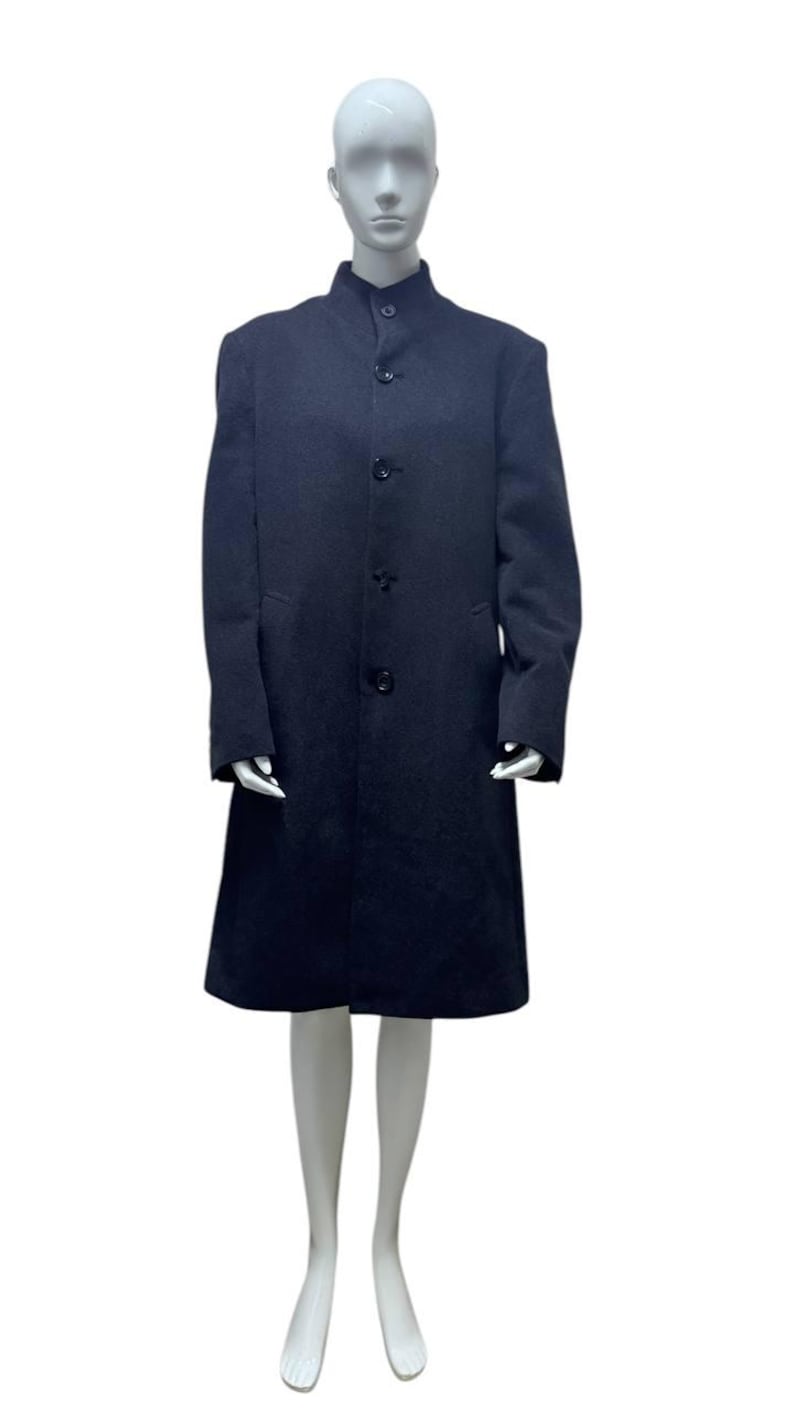 May include: A long, dark blue coat with a mandarin collar and four buttons down the front.
