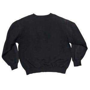 Vintage Nike crewneck sweatshirt featuring iconic spellout logo in classic black, Y2K sportswear style with relaxed unisex fit, perfect for streetwear, casual everyday wear, and vintage Nike collectors worldwide.