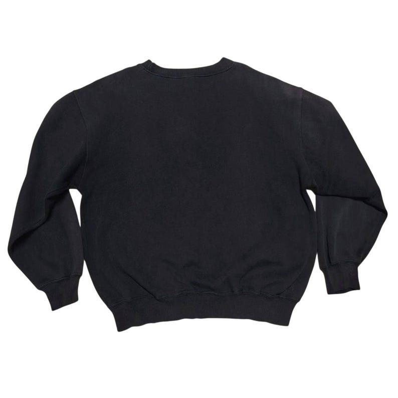 Vintage Nike crewneck sweatshirt featuring iconic spellout logo in classic black, Y2K sportswear style with relaxed unisex fit, perfect for streetwear, casual everyday wear, and vintage Nike collectors worldwide.