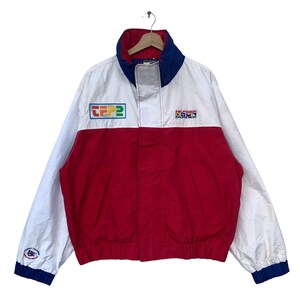 May include: A white, red, and blue windbreaker jacket with the text "HILFIGER RACING GEAR" and "TFP2" on the front.