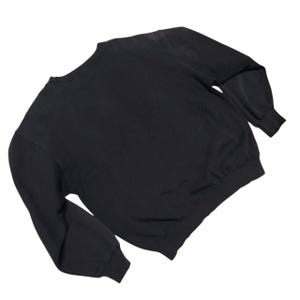 Vintage Nike crewneck sweatshirt featuring iconic spellout logo in classic black, Y2K sportswear style with relaxed unisex fit, perfect for streetwear, casual everyday wear, and vintage Nike collectors worldwide.