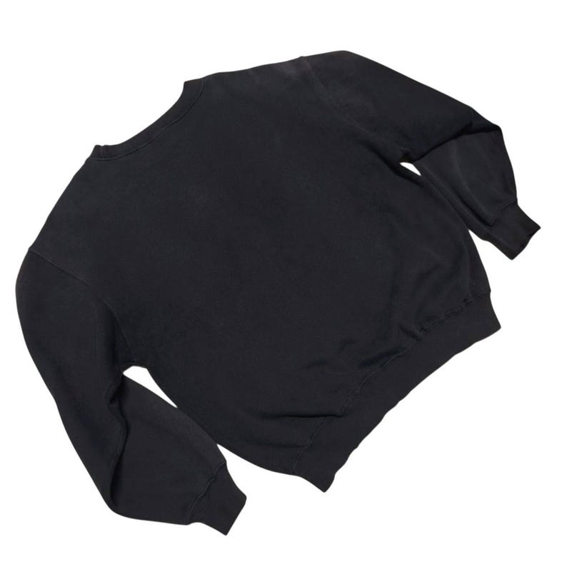 Vintage Nike crewneck sweatshirt featuring iconic spellout logo in classic black, Y2K sportswear style with relaxed unisex fit, perfect for streetwear, casual everyday wear, and vintage Nike collectors worldwide.