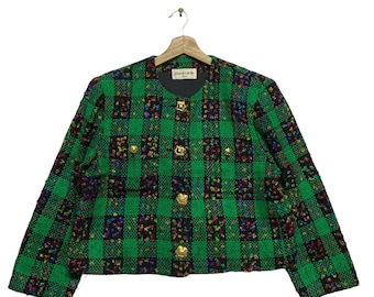 May include: A green, black, and multi-colored plaid blazer with gold buttons. The blazer has a small label that says "Pierre Cardin" on the front.