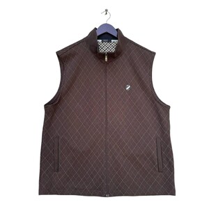 May include: A brown quilted waistcoat with a zip fastening and a small logo on the front. The waistcoat has a diamond pattern and two pockets on the sides.