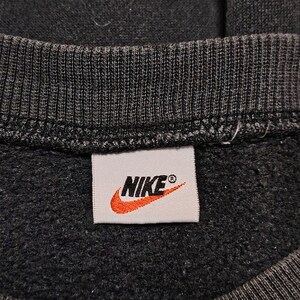 Vintage Nike crewneck sweatshirt featuring iconic spellout logo in classic black, Y2K sportswear style with relaxed unisex fit, perfect for streetwear, casual everyday wear, and vintage Nike collectors worldwide.