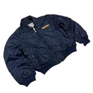 Vintage Avirex MA 1 Bomber Jacket Navy USA Flight Jacket 90s Streetwear Military Jacket Classic Zip Up Nylon Bomber Coat For Men And Women Rare Avirex USA Outerwear Piece With Iconic Back Logo Design.