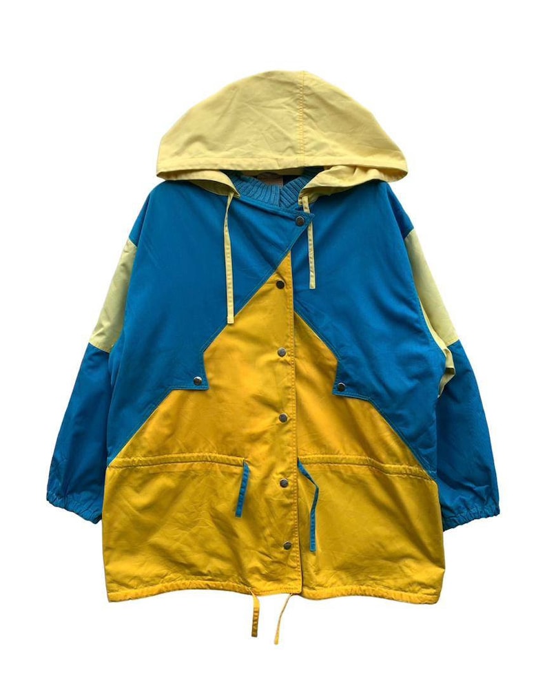 May include: A yellow, blue, and light yellow hooded jacket with a drawstring waist and snap closure.