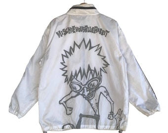 May include: White windbreaker jacket with a black zip and black trim. The back of the jacket features a graphic of a cartoon character with the text "Mischievous Biller Rabbit".