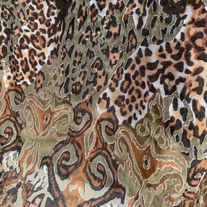 May include: A brown and green fabric with a leopard print and a paisley pattern.