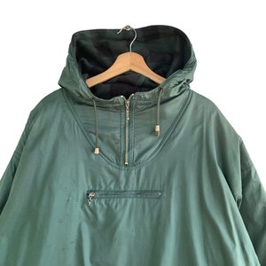 May include: A green hooded jacket with a zipper closure and a fleece lining. The jacket has a drawstring hood and a kangaroo pocket.