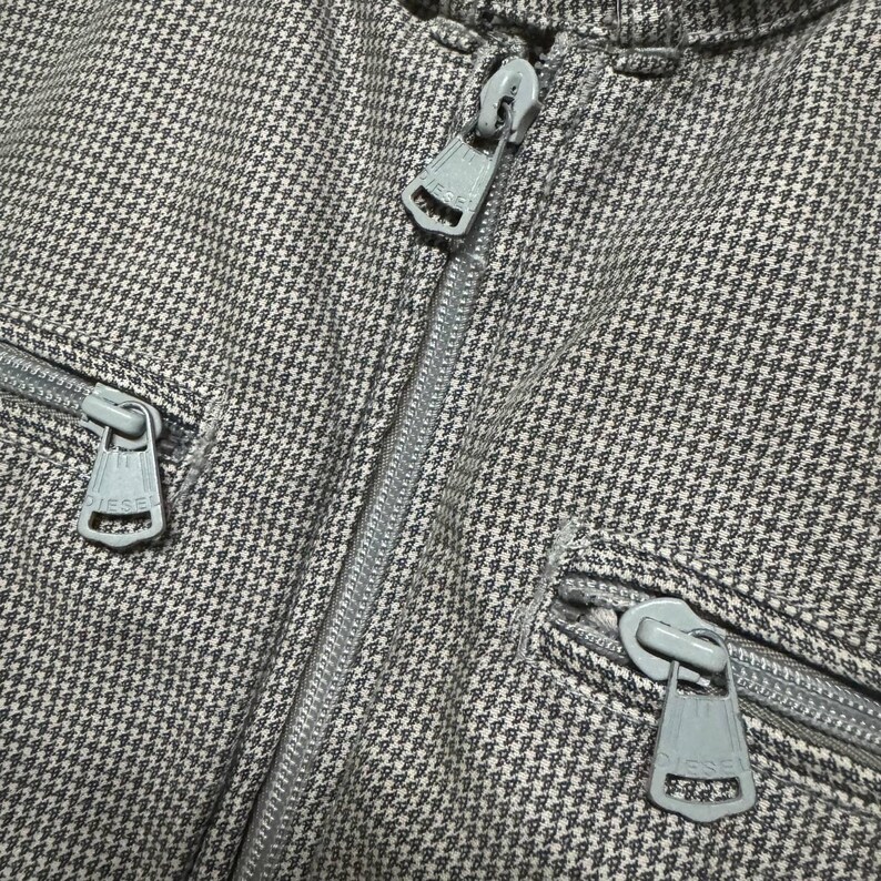 A vintage Diesel moto biker jacket with a checkered design featuring a full zip front, utility pockets and a streetwear aesthetic. Perfect for casual layering unisex fashion.