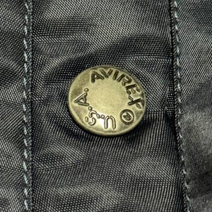 Vintage Avirex MA 1 Bomber Jacket Navy USA Flight Jacket 90s Streetwear Military Jacket Classic Zip Up Nylon Bomber Coat For Men And Women Rare Avirex USA Outerwear Piece With Iconic Back Logo Design.