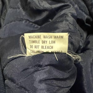 Vintage Avirex MA 1 Bomber Jacket Navy USA Flight Jacket 90s Streetwear Military Jacket Classic Zip Up Nylon Bomber Coat For Men And Women Rare Avirex USA Outerwear Piece With Iconic Back Logo Design.