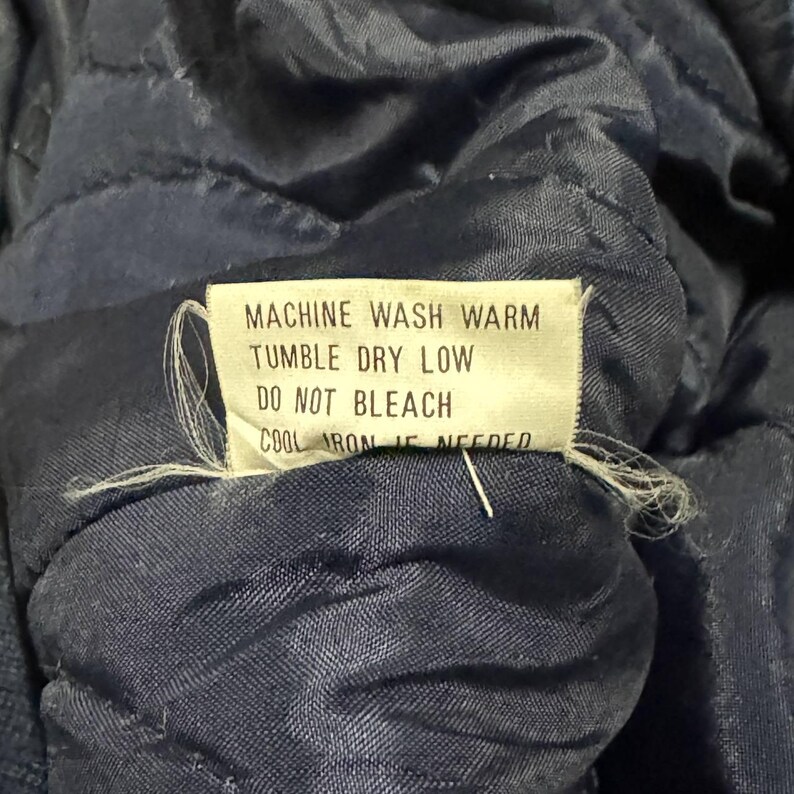 Vintage Avirex MA 1 Bomber Jacket Navy USA Flight Jacket 90s Streetwear Military Jacket Classic Zip Up Nylon Bomber Coat For Men And Women Rare Avirex USA Outerwear Piece With Iconic Back Logo Design.