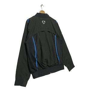May include: Black windbreaker jacket with blue accents and a Nike swoosh logo on the back.