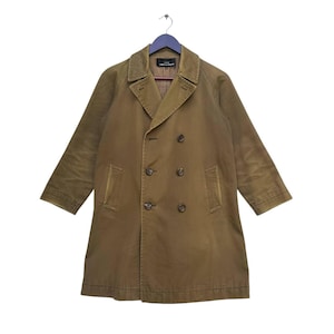 May include: A brown double-breasted coat with a notched collar and four buttons. The coat has two front pockets and long sleeves. The coat is hanging on a blue hanger.
