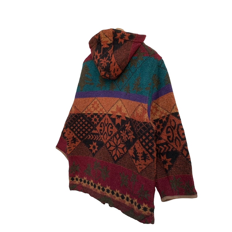 May include: A hooded jacket with a colorful geometric pattern in shades of red, orange, purple, blue, and green. The jacket has a drawstring hood and a zipper closure.