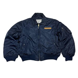 Vintage Avirex MA 1 Bomber Jacket Navy USA Flight Jacket 90s Streetwear Military Jacket Classic Zip Up Nylon Bomber Coat For Men And Women Rare Avirex USA Outerwear Piece With Iconic Back Logo Design.