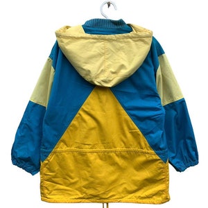 May include: A yellow, blue, and light yellow hooded jacket with a drawstring at the bottom.