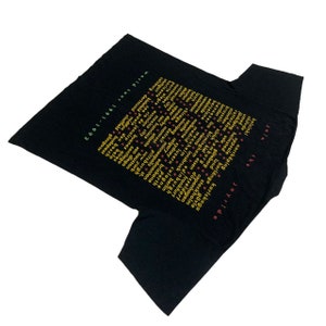 May include: Black t-shirt with yellow text listing cities and countries on the back. The text reads "Join the Joyride" and lists cities and countries from Europe, Australia, North America, and South America. The text "World Tour 1991-1992" is at the bottom.