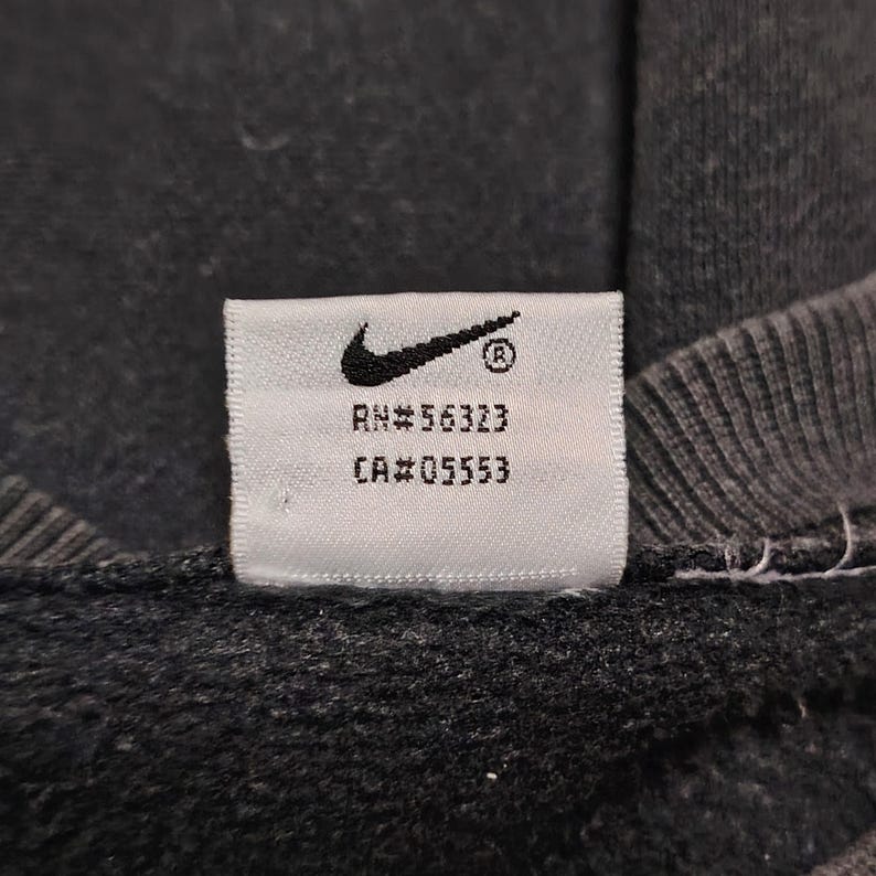 Vintage Nike crewneck sweatshirt featuring iconic spellout logo in classic black, Y2K sportswear style with relaxed unisex fit, perfect for streetwear, casual everyday wear, and vintage Nike collectors worldwide.