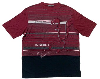 May include: A red and black t-shirt with a graphic print of a cartoon roadrunner. The shirt has a striped pattern and the text "grabbing some... by Green.c Road Runner".