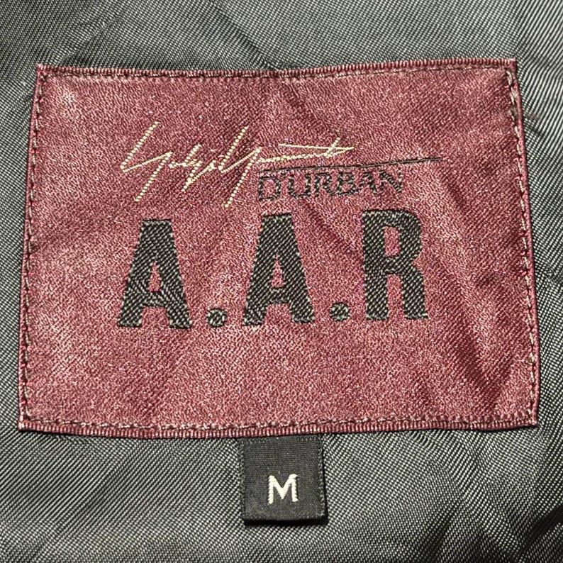 Vintage Mens black wool blend long overcoat featuring a minimalist button up design with stand collar made by A.A.R Durban Urban.Vintage coat ideal for fall and winter streetwear,office wear or layered casual looks.Classic and sleek,perfect for fashion forward individuals seeking timeless urban outerwear.This stylish trench style coat offers comfort,warmth and elegance for everyday city life or formal occasions.