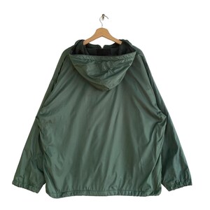 May include: A green hooded jacket with a zipper closure. The jacket has a fleece lining and a drawstring hood.