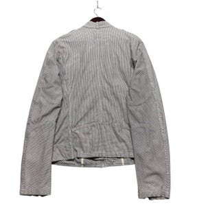 A vintage Diesel moto biker jacket with a checkered design featuring a full zip front, utility pockets and a streetwear aesthetic. Perfect for casual layering unisex fashion.