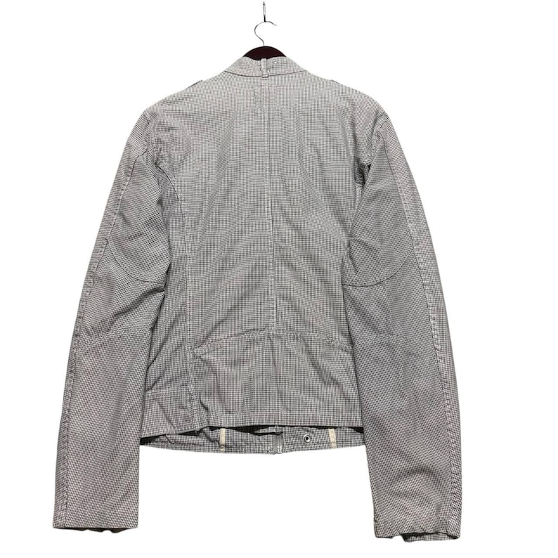 A vintage Diesel moto biker jacket with a checkered design featuring a full zip front, utility pockets and a streetwear aesthetic. Perfect for casual layering unisex fashion.
