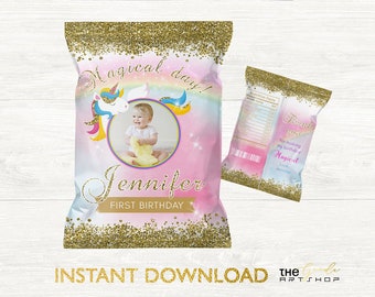 May include: A personalized chip bag design for a first birthday. The design features a unicorn, a photo of a baby, and the text "Magical day!" and "Jennifer First Birthday". The bag has a gold glitter border and a pastel rainbow background.