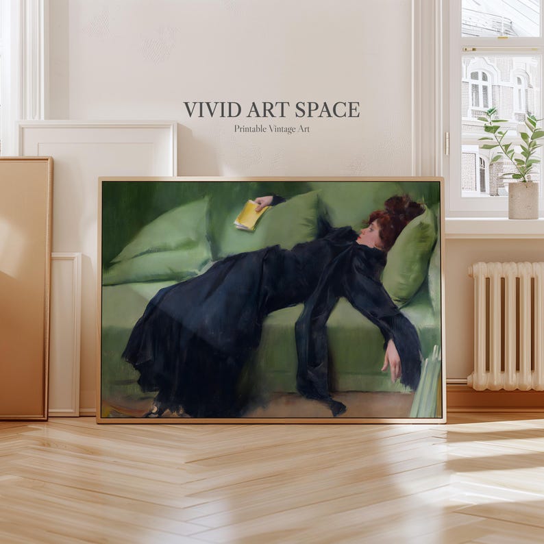 May include: A framed vintage art print depicting a woman in a black dress resting on a green sofa, holding a yellow book. The artwork is labelled "VIVID ART SPACE Printable Vintage Art."