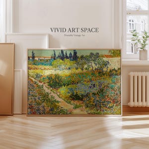 May include: A framed landscape painting with a path leading through a field of colorful flowers and greenery. The artwork features a bridge and trees under a blue sky. The text "VIVID ART SPACE Printable Vintage Art" is at the top.
