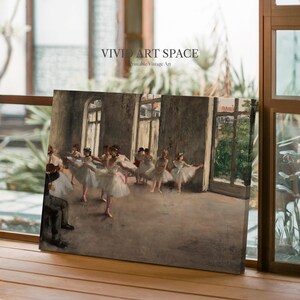 May include: A canvas print of a ballet class in a dance studio. The artwork depicts ballerinas in white tutus and pink ribbons, with a man playing a violin. The text "VIVID ART SPACE" is visible.