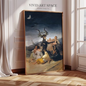 May include: A framed print of a dark, dramatic painting featuring a horned figure surrounded by people. The artwork has a gold frame and is displayed against a white wall. The text "VIVID ART SPACE Printable Vintage Art" is at the top.